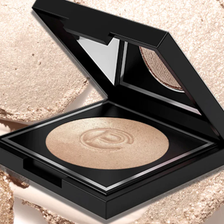 Three layers of crushed makeup powder in pink, beige, and brown shades, with a textured look