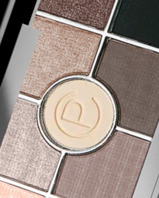 Crushed eyeshadow swatches in brown, beige, and shimmering gold tones on a white background