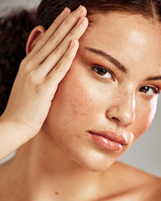 Female model showing of her face with shiny skin