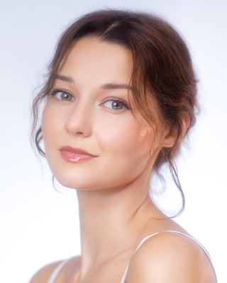 ChatGPT said: Model wears shimmering sheer Pure Cosmetics Light Up Lip Gloss for a radiant, glowing lip look.