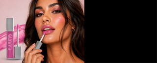 Woman applying soft pink lip gloss with light sparkle with product image and swatch in the background