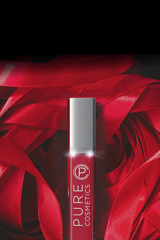 Pure Cosmetics Femme Fatale red lip gloss amid holiday ribbon – luxury high-shine color for holiday glam and gifting season.