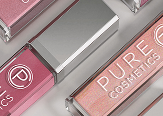 Image of Pure Light Up Lip Gloss in multiple shades laying on grey surface background.